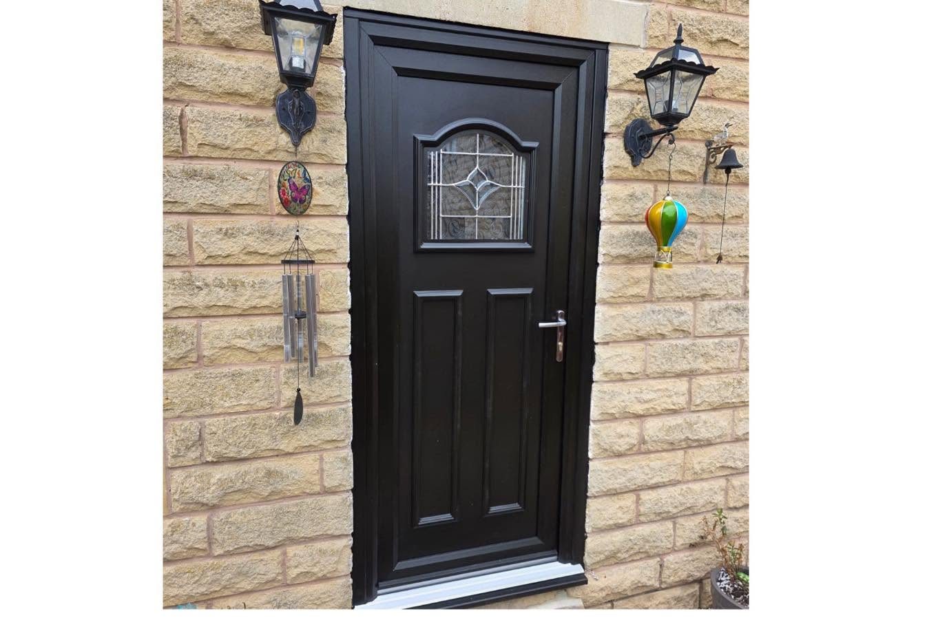 Black composite front door with decorative glass