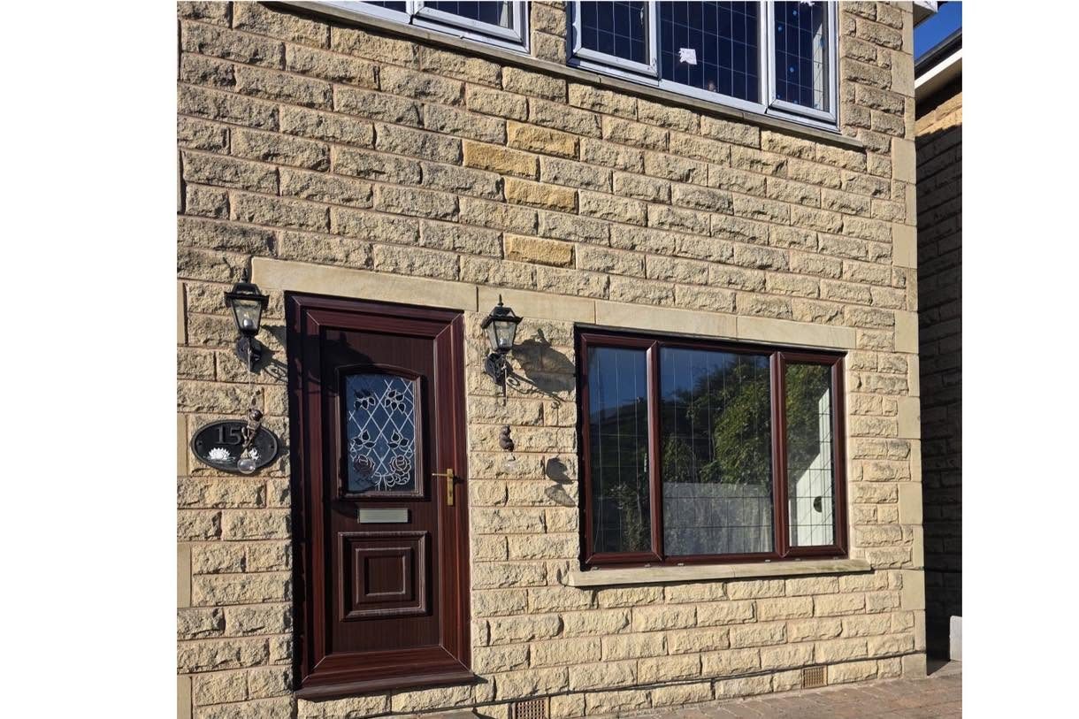 Rosewood door and window on stone home
